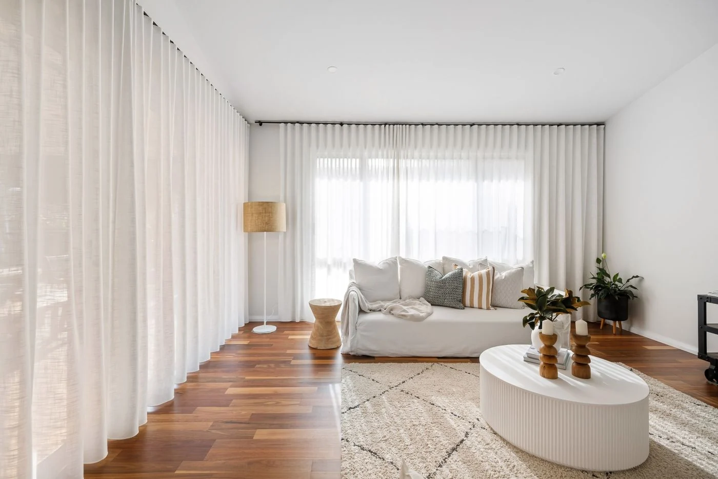 Wohnzimmer mit Vorhängen und Polstermöbeln